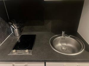 a kitchen counter with a sink and a counter at EFA in Villeurbanne
