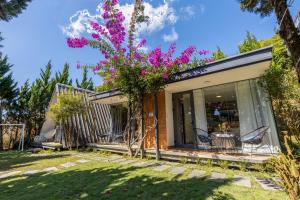 a house with purple flowers on the side of it at Perfect Homestay in Xuan An