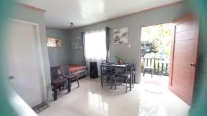 a living room with a table and a dining room at Bohol Stays in Tagbilaran City