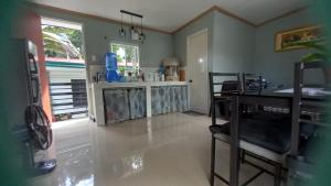 a kitchen with a desk and a table in a room at Bohol Stays in Tagbilaran City +1 photo