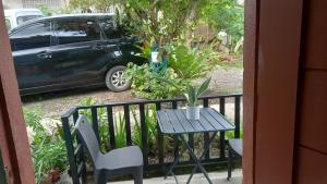 a table and chair on a balcony with a car at Bohol Stays in Tagbilaran City