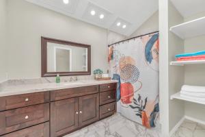 a bathroom with a sink and a mirror at Modern Accessible Houston Gem Jacuzzi & Air Hockey 6Beds in Houston +65 photos
