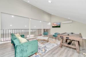 a living room with a couch and a table at Modern Accessible Houston Gem Jacuzzi & Air Hockey 6Beds in Houston