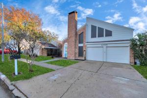 a brick house with a white garage at Modern Accessible Houston Gem Jacuzzi & Air Hockey 6Beds in Houston