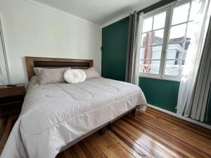 a bedroom with a bed and a large window at Casa Di Patti in Santiago