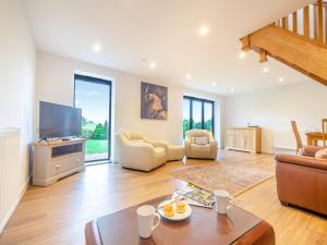 a living room with a couch and a tv at Arenig View - Uk46081 in Frongoch