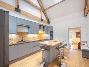 a kitchen with white cabinets and a wooden counter top at Arenig View - Uk46081 in Frongoch