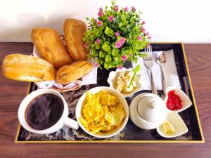 - un plateau avec des aliments pour le petit-déjeuner et une tasse de café dans l'établissement Hospedaje Celerina & Elio, à Lima