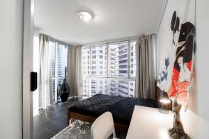 a bedroom with a bed and a large window at Prime location - CBD Brisbane 1 bed w shared 25m pool, gym, sundeck and a BBQ area in Brisbane