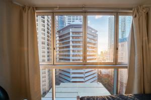 a large window with a view of a city at Prime location - CBD Brisbane 1 bed w shared 25m pool, gym, sundeck and a BBQ area in Brisbane