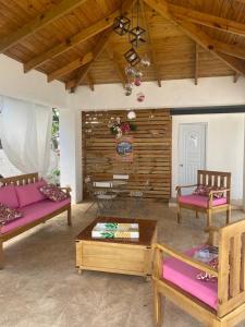 a living room with two couches and a table at Villa Grecko Place in Jarabacoa