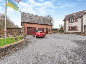 a red car parked in front of a house at The Apartment - Uk45103 in Hoel-galed