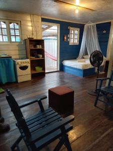 a bedroom with a bed and a bench in a room at Casa elba sobre el mar in Bocas del Toro