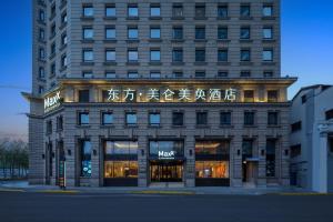 a building with a sign on the front of it at Maxx by Steigenberger on the Bund Shanghai in Shanghai