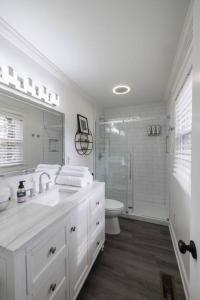 a white bathroom with a sink and a shower at 2BR 2Bath Chamblee Brookhaven Ashford Park Brand new furnishings throughout in Atlanta