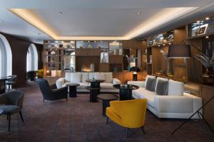 a lobby with couches and tables and chairs at Skopje Marriott Hotel in Skopje