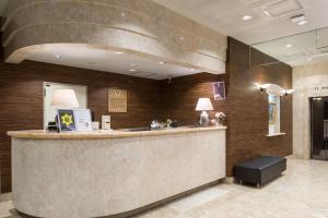 a lobby of a hotel with a reception counter at Urvest Hotel Kamata in Tokyo