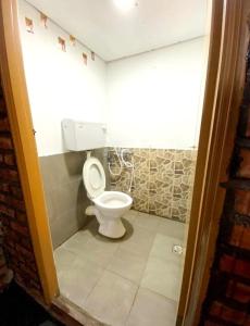 a bathroom with a toilet in a small room at SB SUNSET KUCHING in Kuching