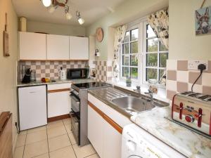 a kitchen with white cabinets and a sink at 1 Bed in Bellingham 89085 in Bellingham