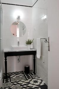 a bathroom with a sink and a mirror at Casa18.55 - Time with history in São Brás de Alportel