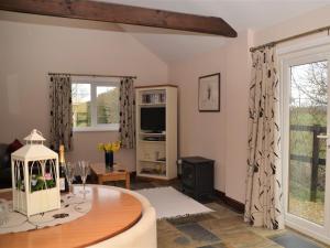 a living room with a table and a large window at 1 bed in Bradford-on-Avon 58771 in Erlestoke