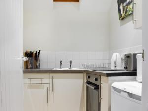 a kitchen with a sink and a counter top at The Six Bells Barn in Sudbury