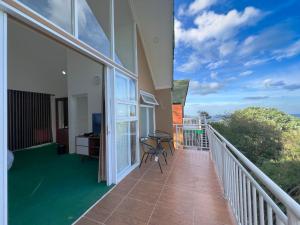 a balcony of a house with a table and chairs at Ciater Dream Village in Cicadas