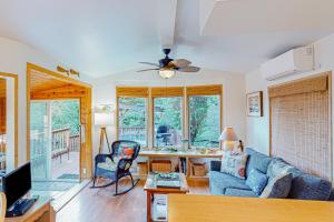 a living room with a blue couch and a table at Whimsical Whaleshead, OV10 in Carpenterville