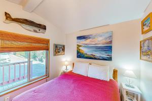 a bedroom with a large pink bed and a window at Whimsical Whaleshead, OV10 in Carpenterville