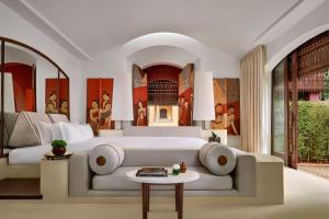 a bedroom with a bed and a couch and a table at Phulay Bay, A Ritz-Carlton Reserve in Tab Kaek Beach