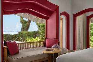 a bedroom with a bed and a large window at Phulay Bay, A Ritz-Carlton Reserve in Tab Kaek Beach