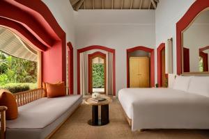 a bedroom with a bed and a couch at Phulay Bay, A Ritz-Carlton Reserve in Tab Kaek Beach