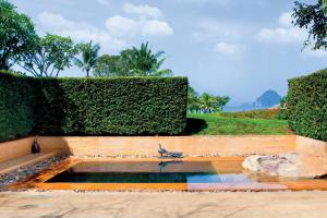 a bird sitting on top of a water fountain at Phulay Bay, A Ritz-Carlton Reserve in Tab Kaek Beach