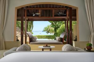 a living room with two couches and a table at Phulay Bay, A Ritz-Carlton Reserve in Tab Kaek Beach