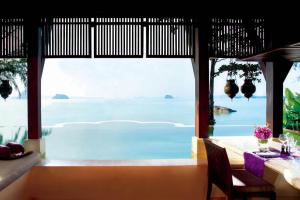 a dining room with a view of the ocean at Phulay Bay, A Ritz-Carlton Reserve in Tab Kaek Beach