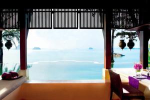 a dining room with a view of the ocean at Phulay Bay, A Ritz-Carlton Reserve in Tab Kaek Beach