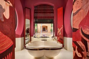 a bathroom with a large white tub in a pink room at Phulay Bay, A Ritz-Carlton Reserve in Tab Kaek Beach
