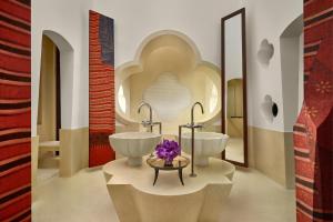 a bathroom with two sinks and a mirror at Phulay Bay, A Ritz-Carlton Reserve in Tab Kaek Beach