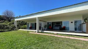 a white house with a patio and a yard at Casitas Sollevante Boutique Hotel in Montezuma