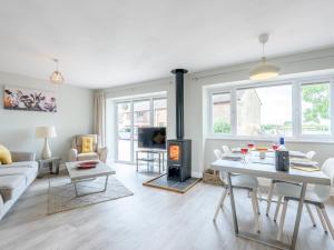 a living room with a table and a fireplace at 2 Bed in Newent 78696 in Aston Ingham
