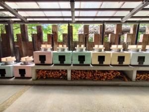 a group of machines sitting on top of wood chips at Kofukaku Kuwarubi in Fujikawaguchiko