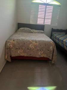 1 dormitorio con cama y ventana en Sitio Igarapé, en Igarapé