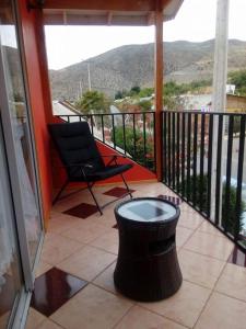 een balkon met een stoel en een tafel op een veranda bij Departamento Puclaro in Vicuña