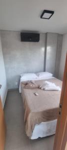 a bedroom with two beds and a television on the wall at Maracabeach2 / 201 in Porto De Galinhas