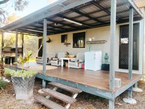 a wooden deck with a pergola on a house at Sonnys Piece Of Paradise in Agnes Water