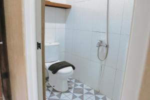 a bathroom with a toilet and a shower at Hotel Solaris Malioboro in Jetis