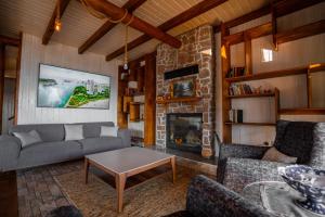 a living room with a couch and a fireplace at Lake360 in Boyalıca