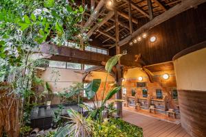 a room with chairs and plants in a building at Shorenkan Yoshinoya in Kyotango