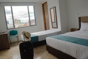Voodi või voodid majutusasutuse Hotel Royal Cid Bogota toas
