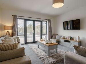 a living room with a couch and a table at 2 Bed in Usk 82392 in Trostrey